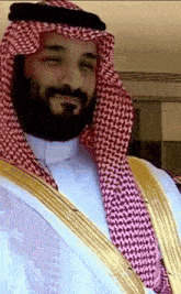 a man with a beard wearing a white shirt and a gold robe