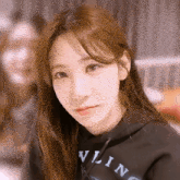 a girl wearing a black hoodie that says vling on it