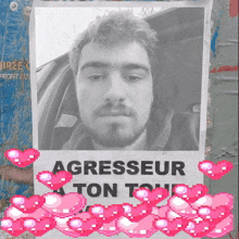 a poster with a picture of a man and the words agresseur a ton tou