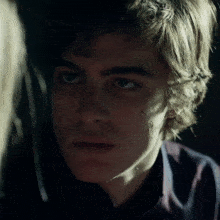 a close up of a young man 's face with a tear on his cheek