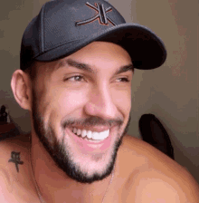a man with a beard wearing a hat that says xk on it