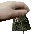 a close up of a person 's hand holding a piece of metal