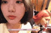 a close up of a girl 's face with jiwon written on the bottom right