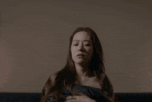 a woman sitting on a couch with the words oh no on the bottom