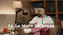 a man is sitting in a chair with the words le lo maro dickraaa written above him