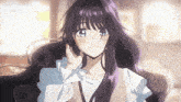a girl with long purple hair is smiling and holding her hair