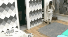 a woman is standing in a room with a sliding door .
