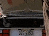 a white car has a license plate that says 3272153
