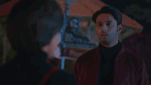 a man and a woman are standing next to each other .