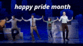 a group of people dancing on a stage with the words happy pride month written above them