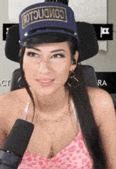 a woman wearing a blue hat that says ' commclo ' on it