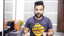 a man with a beard wears a black shirt that says winner winner dinner
