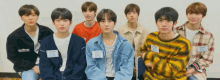 a group of young men are posing for a picture and one of them has a name tag that says ' aoa '