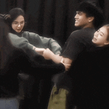 a group of people are hugging each other and one of them has a t-shirt that says t-shirt