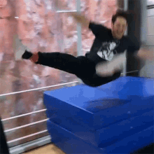 a man wearing a t-shirt that says ' a ' on it is jumping in the air
