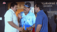 three men are shaking hands in front of a sign that says elaramani
