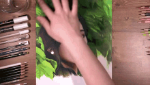 a person 's hand is reaching out to touch a drawing of a woman