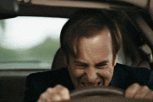 a man is driving a car with his mouth open