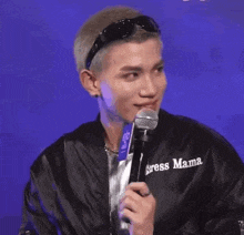 a man wearing sunglasses and a jacket that says sress mama on it