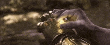 a close up of a person 's hand holding a light .