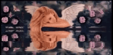 a statue of a woman with wings is reflected in a mirror