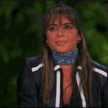 a woman wearing a black jacket and a blue scarf around her neck with the word duan on it