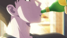 a man is drinking from a green bottle with a yellow cap