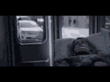 a woman is laying in a hospital bed with a neck brace on her head