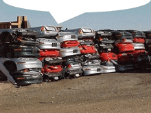 a bunch of cars are stacked on top of each other in a pile