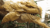 a statue of a dragon with a very large mouth and teeth
