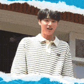 a young man wearing a striped shirt with a nike logo on it