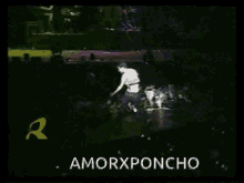 a man stands on a stage in front of a crowd with the words amorxponcho on the bottom