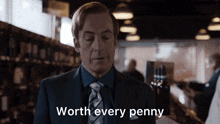 a man in a suit and tie says " worth every penny " in a store