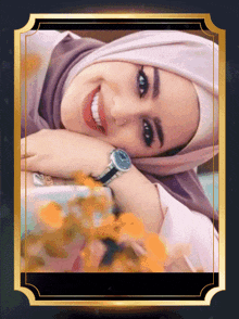 a woman wearing a purple hijab and a watch is smiling
