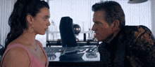 a man and a woman are looking at each other with a surprised look on their faces