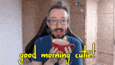 a man holding a cup of coffee with the words good morning cutie written on the bottom