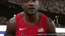 a man in a red nike tank top is talking to someone