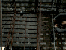 a man is flying through the air in front of a building with the sun shining through it