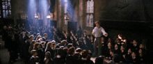 a man stands in front of a large group of people