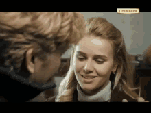 a man and a woman are looking at each other with the word premiera on the bottom