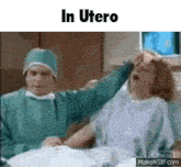 a woman is laying in a hospital bed while a doctor holds her head .