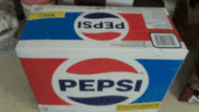 a red white and blue pepsi box sits on a counter