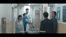a group of people standing in a hallway with a sign that says ' emergency room '