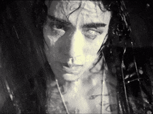 a close up of a person 's face with water coming out of their eyes