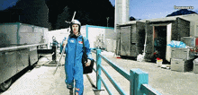 a man wearing a blue jumpsuit and a helmet with the word lewanacta on the bottom