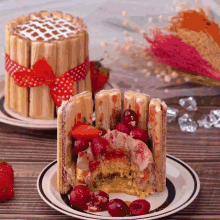 a slice of cake with strawberries and cherries on it