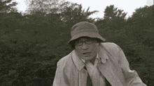 a man wearing a hat and glasses looks shocked