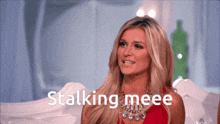 a woman in a red dress is smiling with the words stalking meee below her