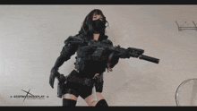 a woman holding a gun with destiny crossplay on the bottom right