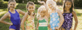 a group of young girls are posing for a picture in their swimsuits